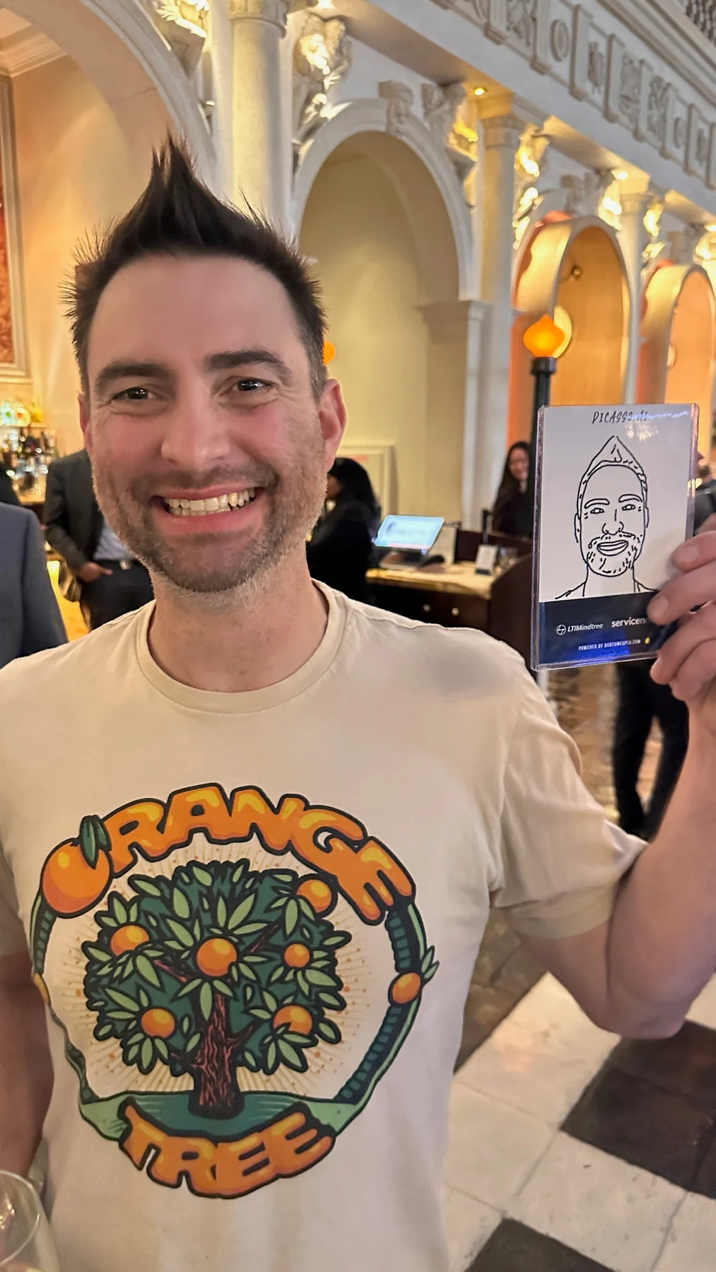 Attendee smiling and holding finished robot sketch