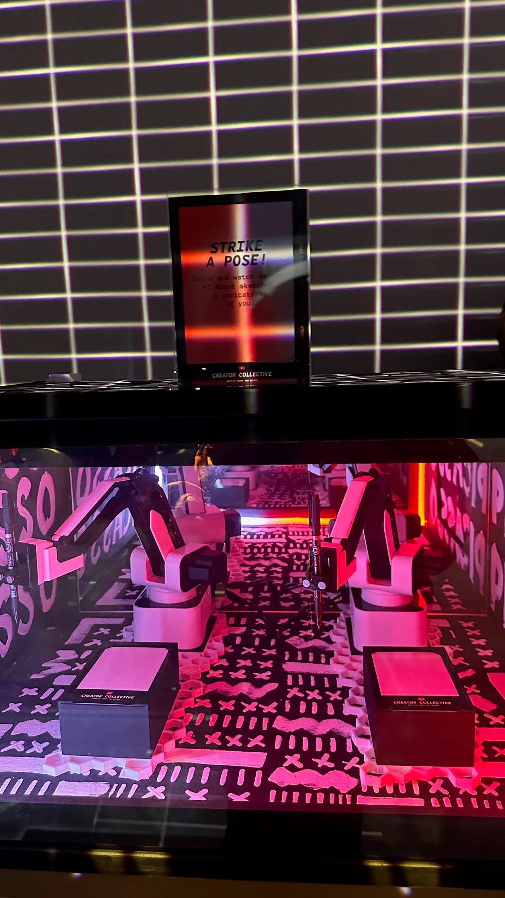 SketchBot drawing station with illuminated pink interior and capture display