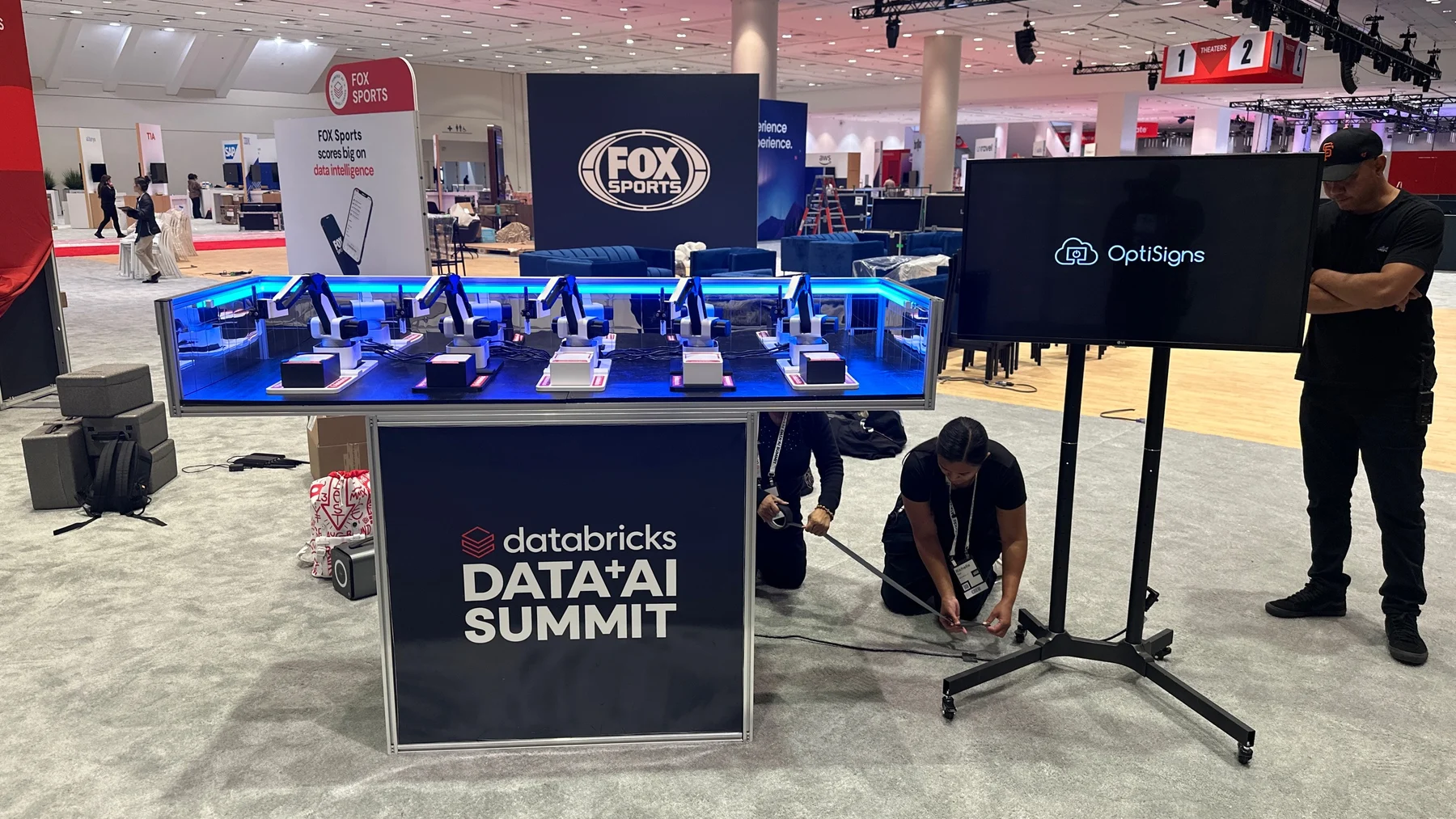 Blue lit drawing station with Databricks Data and AI Summit front branding