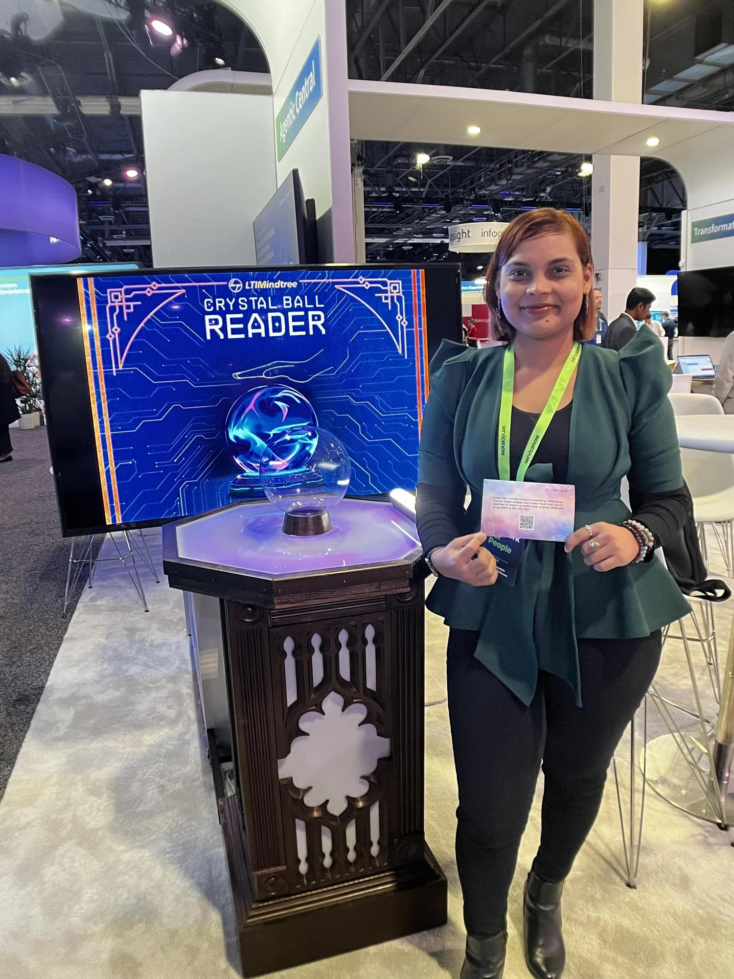 Guest holding her printed reading beside the LTIMindtree Crystal Ball Reader