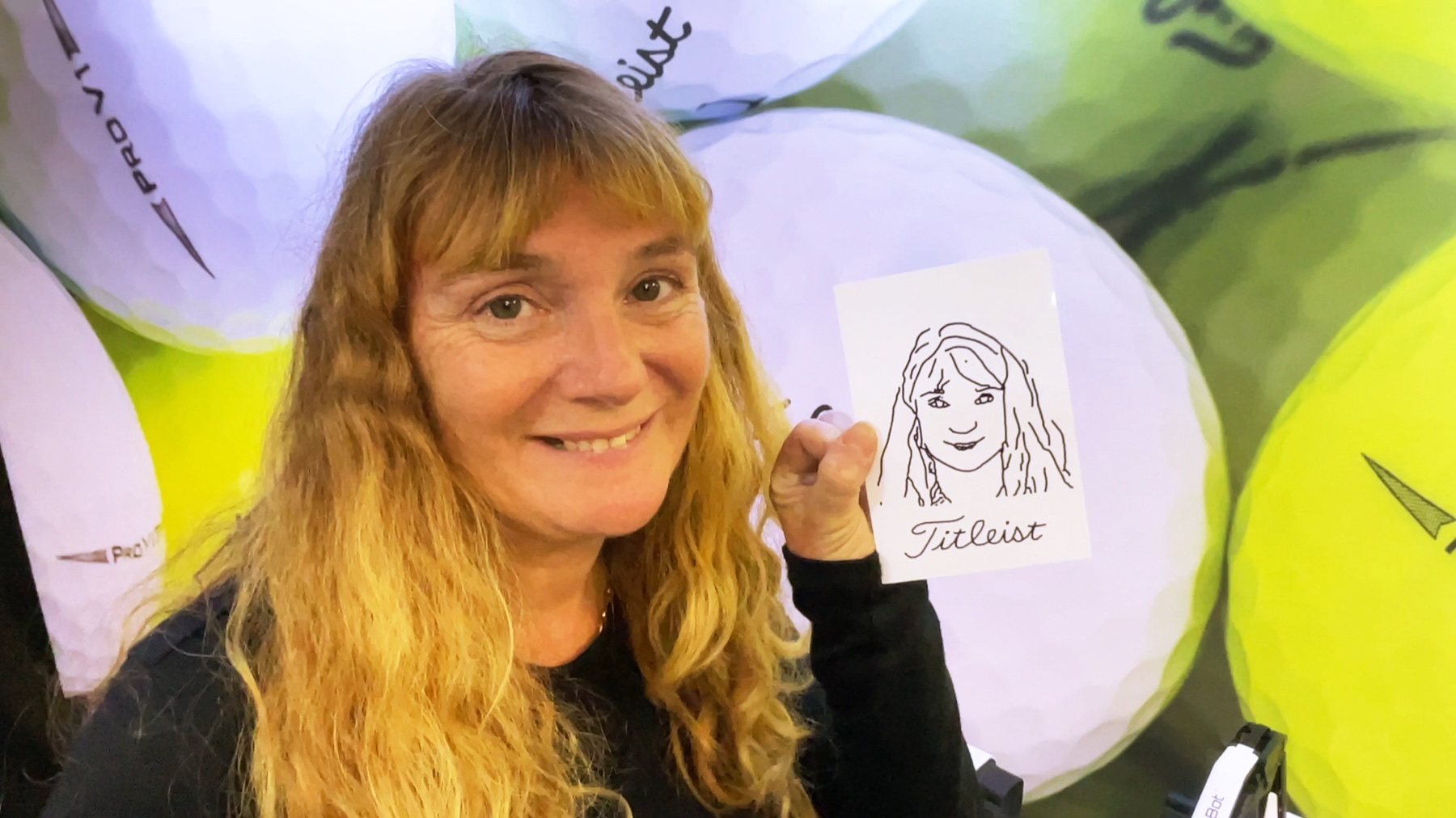 Guest holding a finished robotic portrait sketch at a live BoothMeUp activation