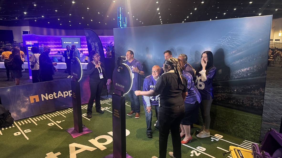 Guests inside a NetApp generative AI trading-card activation produced by BoothMeUp