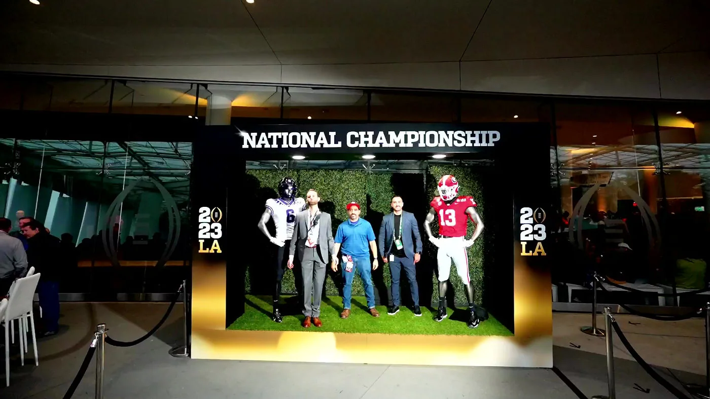 Guests beside the TCU and Georgia uniform display at the 2023 National Championship